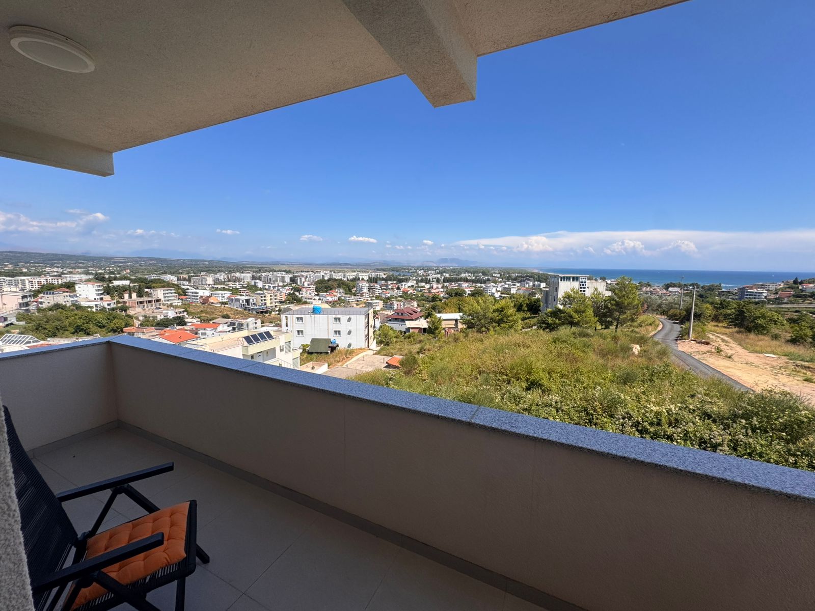 Premium Ulcinj Montenegro property: balcony with lush views, coastline, stylish seating. Top investment via immobilien.ekosphere.me/Ekosphere.