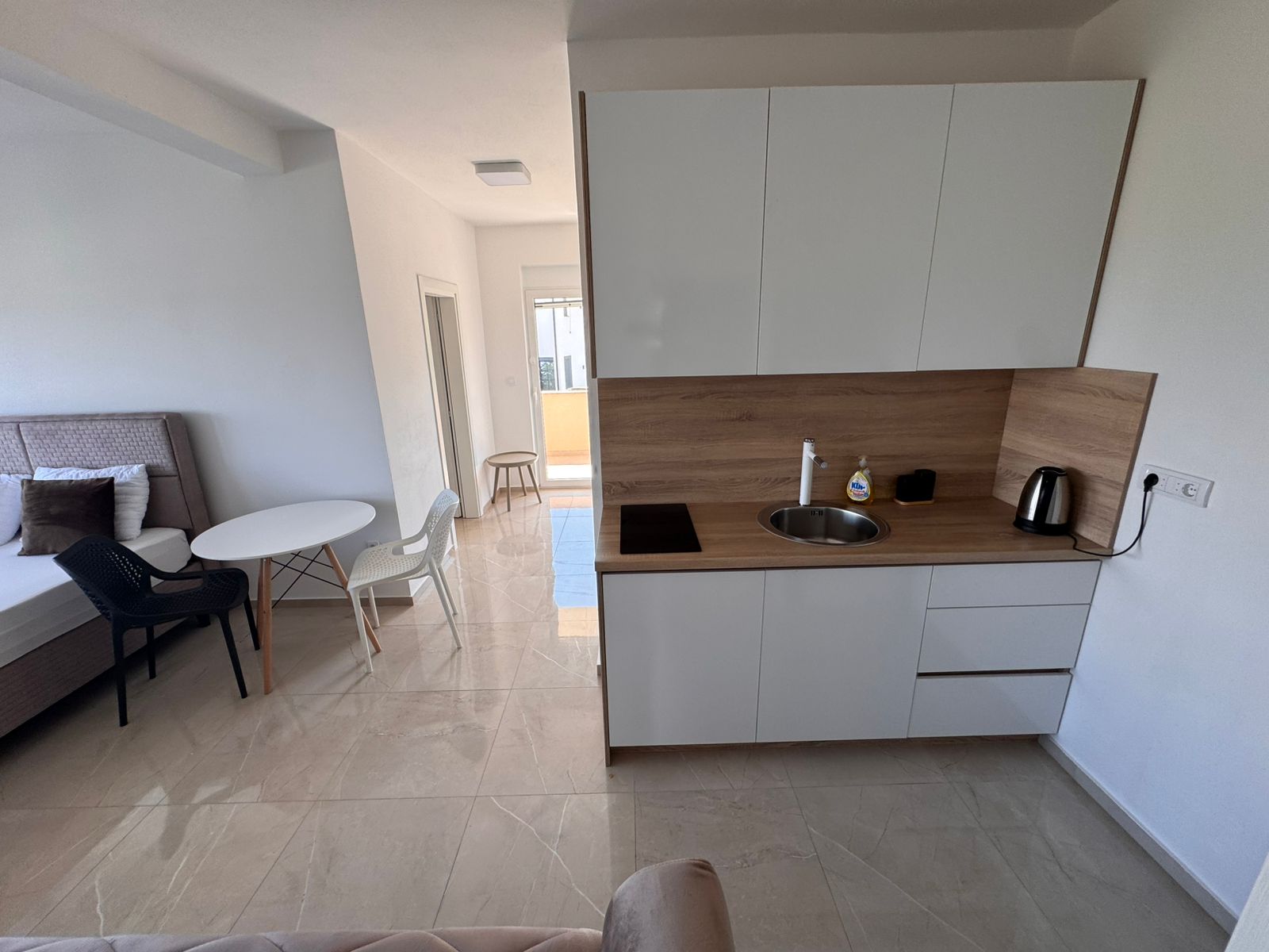 Modern Ulcinj studio: bright living, sleek kitchenette with white cabinets&mdash;exclusive investment via immobilien.ekosphere.me by Ekosphere.