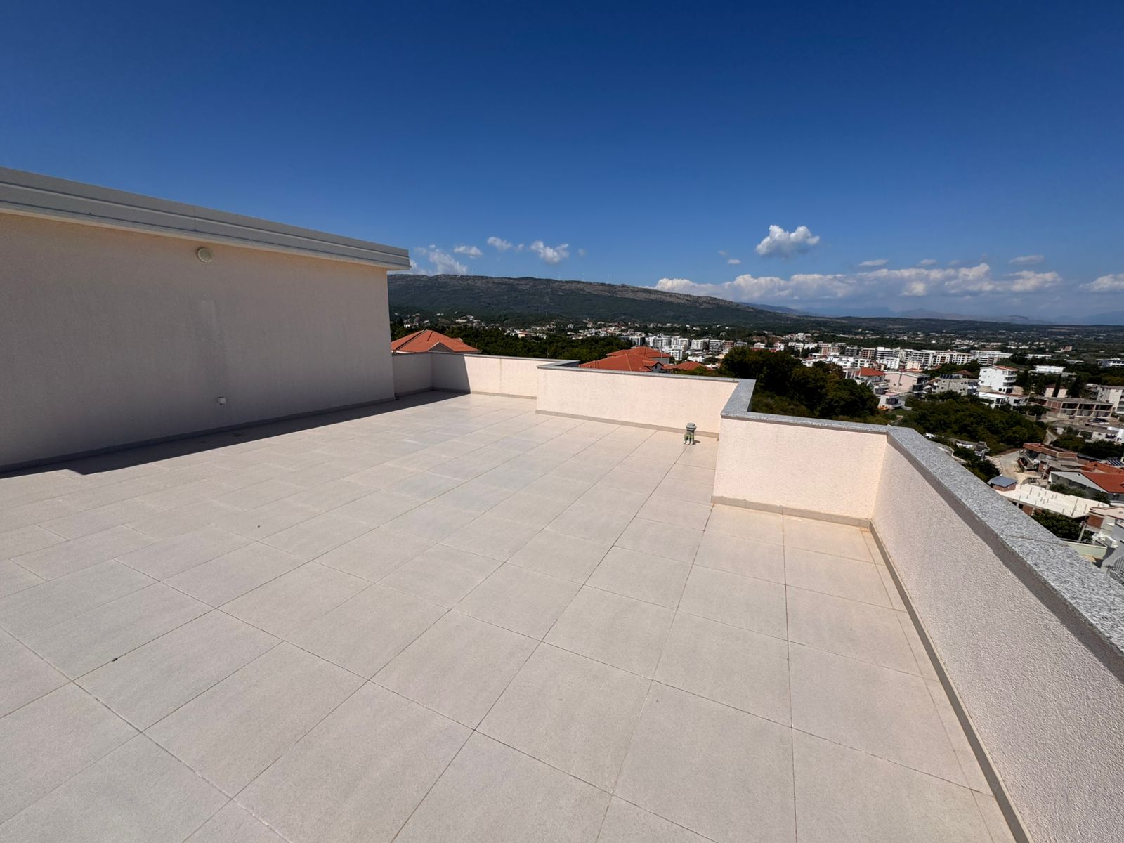 Expansive tiled rooftop terrace with panoramic Ulcinj views&mdash;ideal Montenegro real estate from Ekosphere doo at immobilien.ekosphere.me.