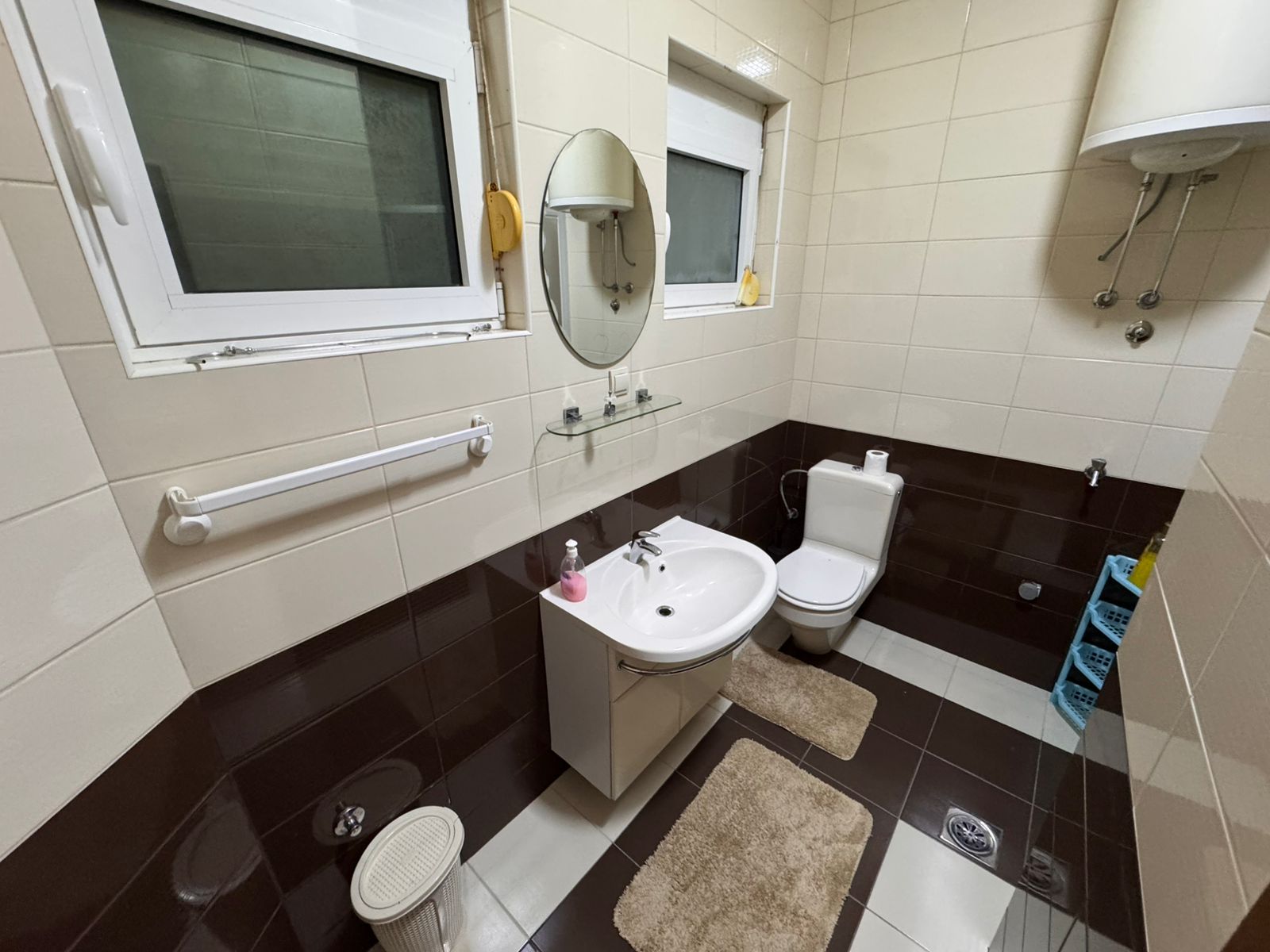 Modern Ulcinj bathroom: stylish beige & brown tiles, premium fixtures, ample storage&mdash;exclusive on immobilien.ekosphere.me by ekosphere doo.