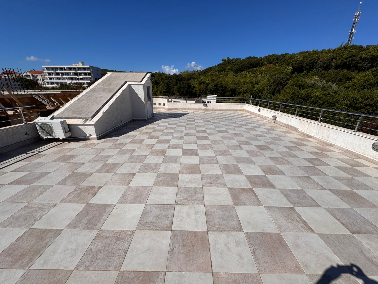 Expansive tiled rooftop terrace in Ulcinj, Montenegro&mdash;ideal for investment. Secure railings, AC units, stunning city views. Exclusive on immobilien.ekosphere.me by ekosphere doo.
