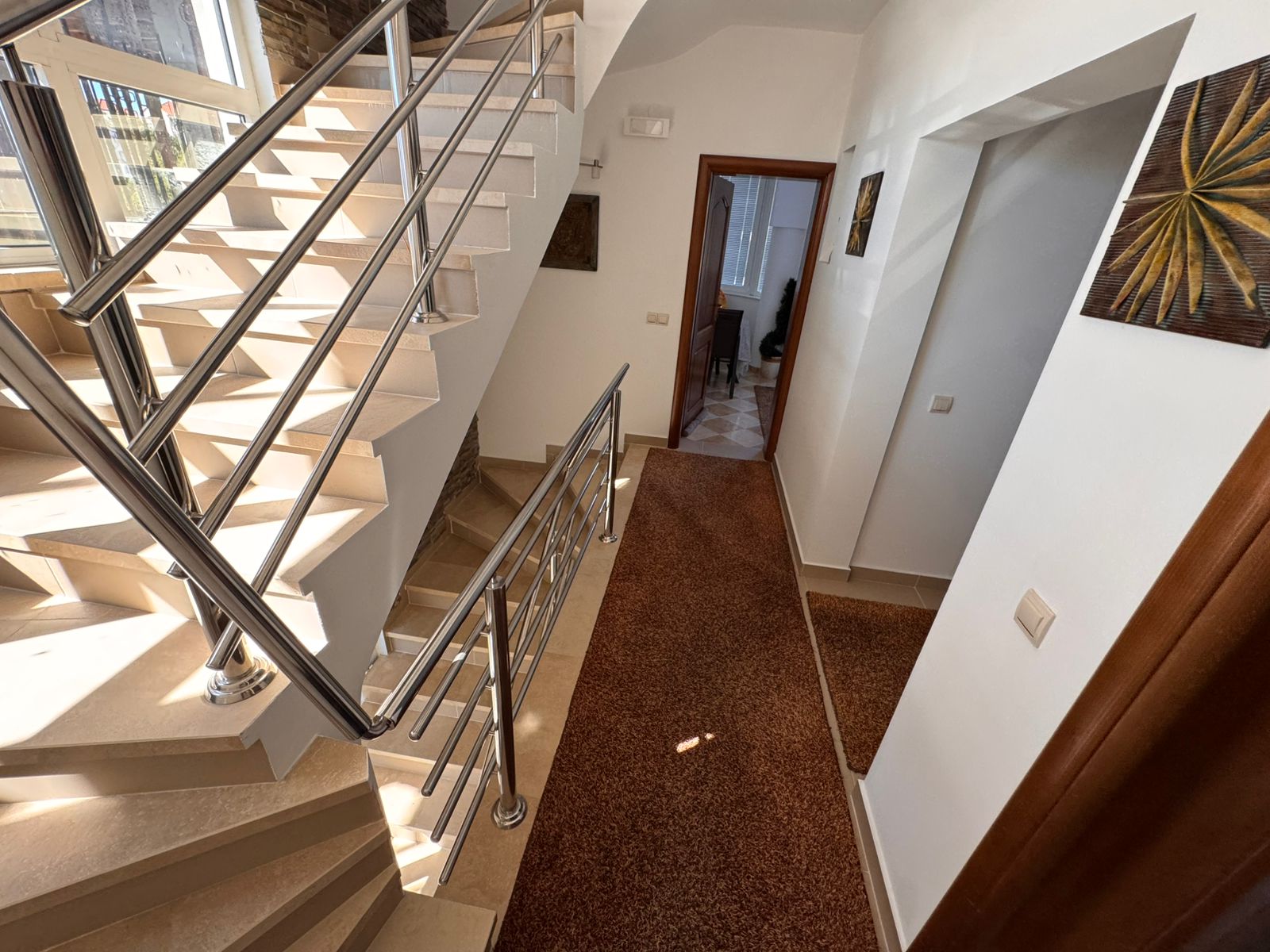 Showcasing a sunlit Ulcinj hallway with modern beige stairs, premium finishes, and investment potential via immobilien.ekosphere.me by ekosphere doo.