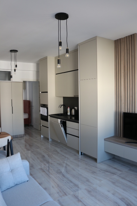 Luxury modern kitchen in Ulcinj, Montenegro with marble floors, top appliances, designer lighting. Invest via immobilien.ekosphere.me by ekosphere doo.