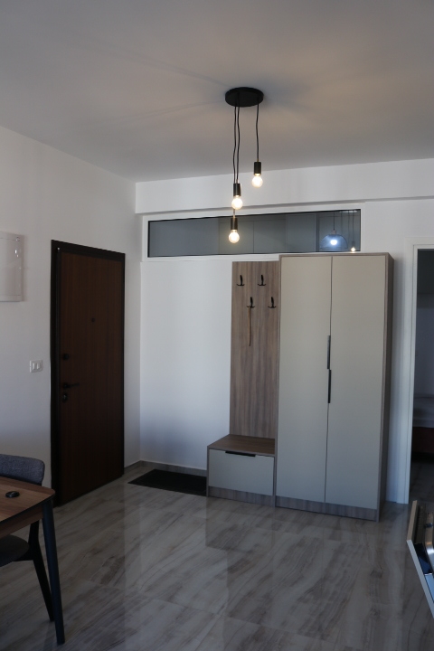 Stylish entryway in Ulcinj with modern wooden door, quality storage, and designer lighting&mdash;exclusive at immobilien.ekosphere.me by ekosphere doo.