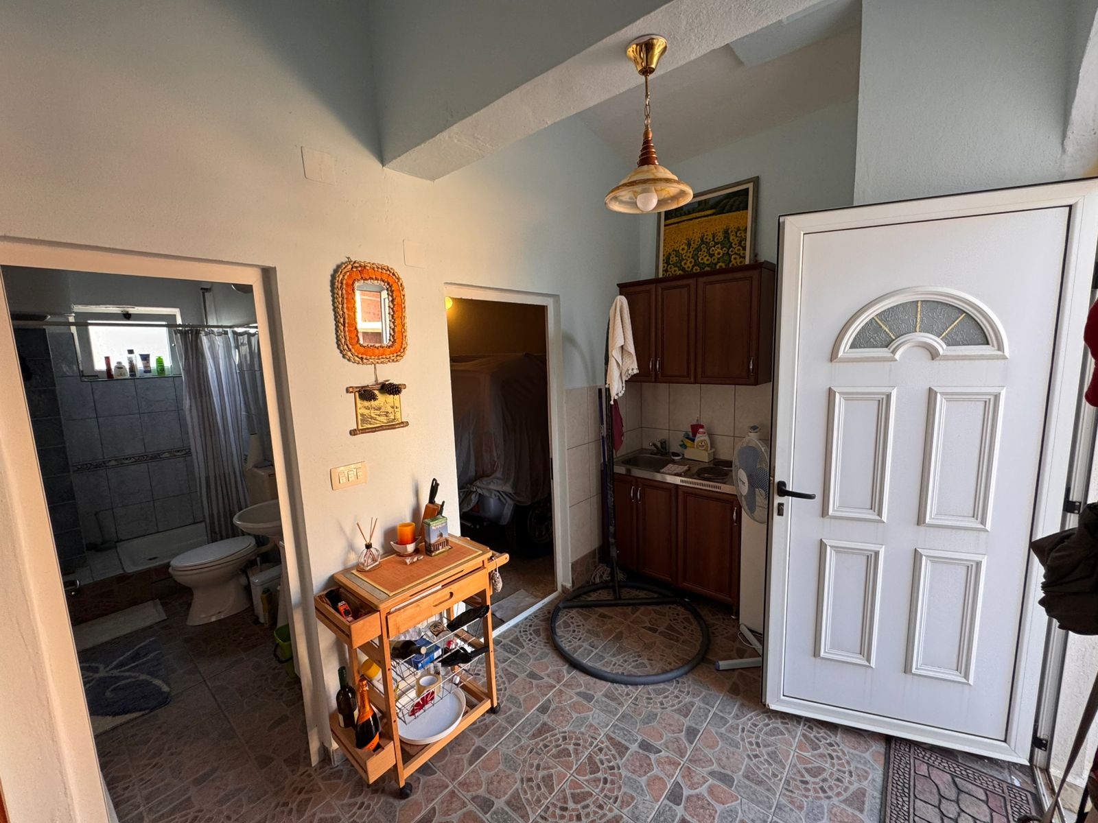 Bright entryway with tiled floors, modern white door, bathroom access, and versatile storage&mdash;ideal Ulcinj investment via immobilien.ekosphere.me.