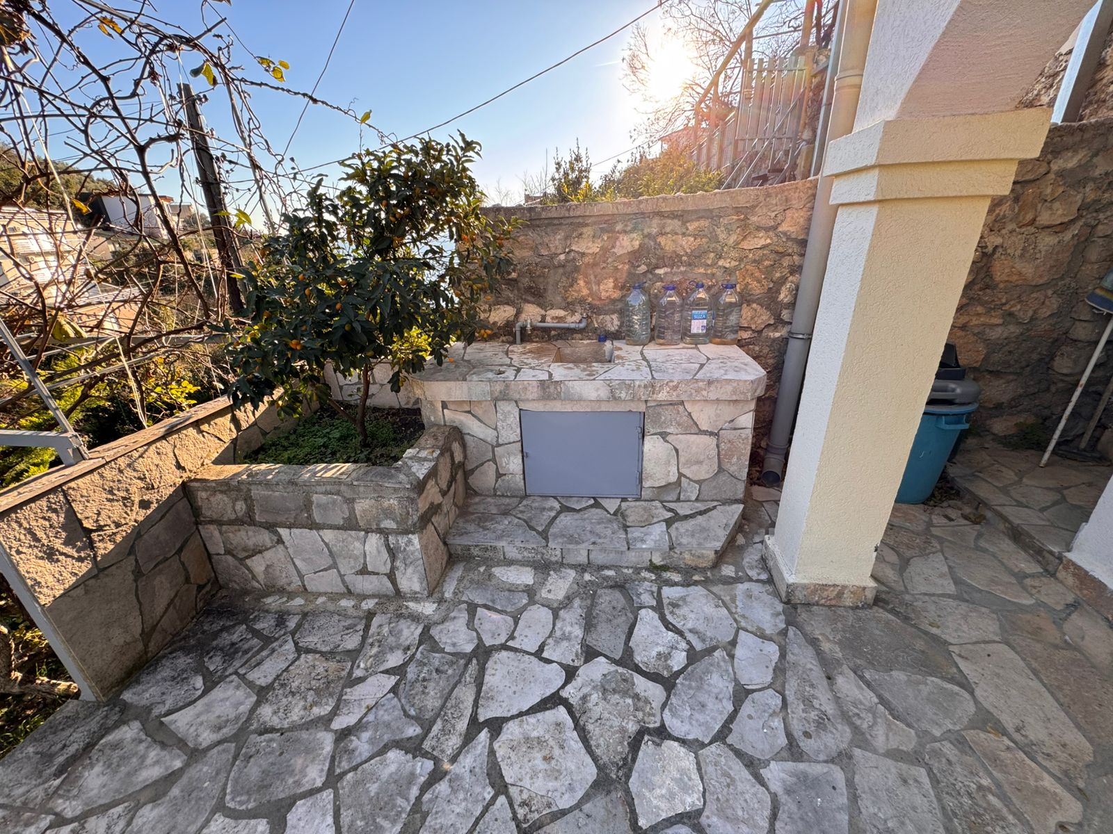 Stunning stone outdoor sink on a sunlit patio in Ulcinj, Montenegro&mdash;ideal investment. Montenegro-listings.me by ekosphere doo.