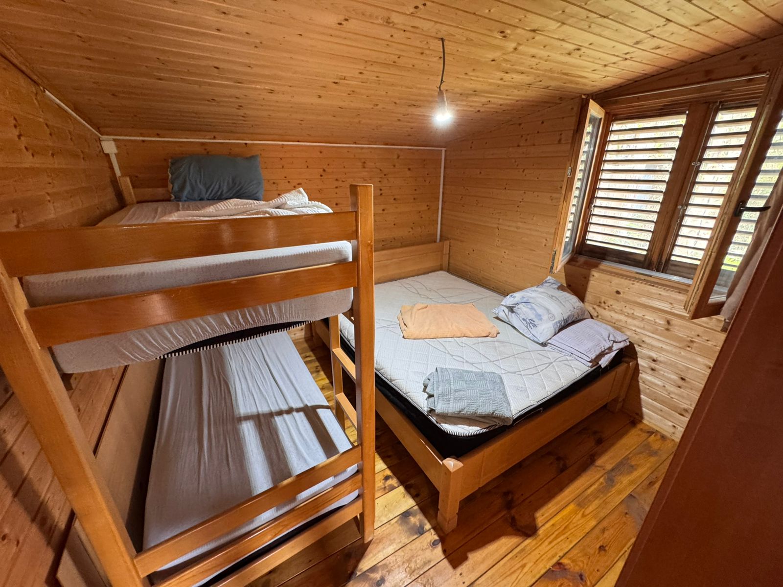 Charming Ulcinj retreat: cozy wood-finished room with bunk and double beds, ideal for Montenegro investment. Eksosphere DOO project.
