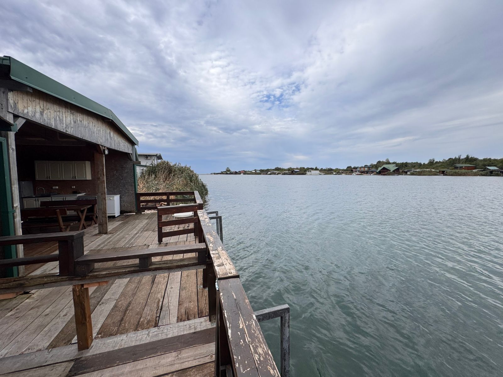 Stunning waterfront deck in Ulcinj, Montenegro&mdash;ideal investment with serene views, benches, and close to shoreline homes. Listed by ekosphere doo.