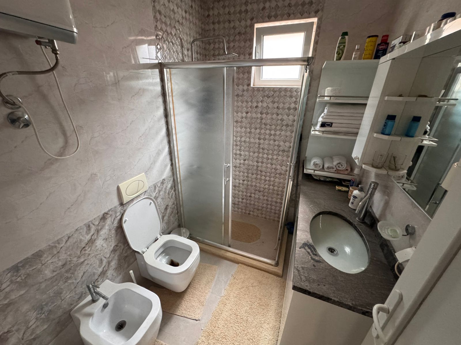 Elegant Ulcinj bathroom with marble walls, glass shower, luxury fittings&mdash;exclusive property via immobilien.ekosphere.me by ekosphere doo.