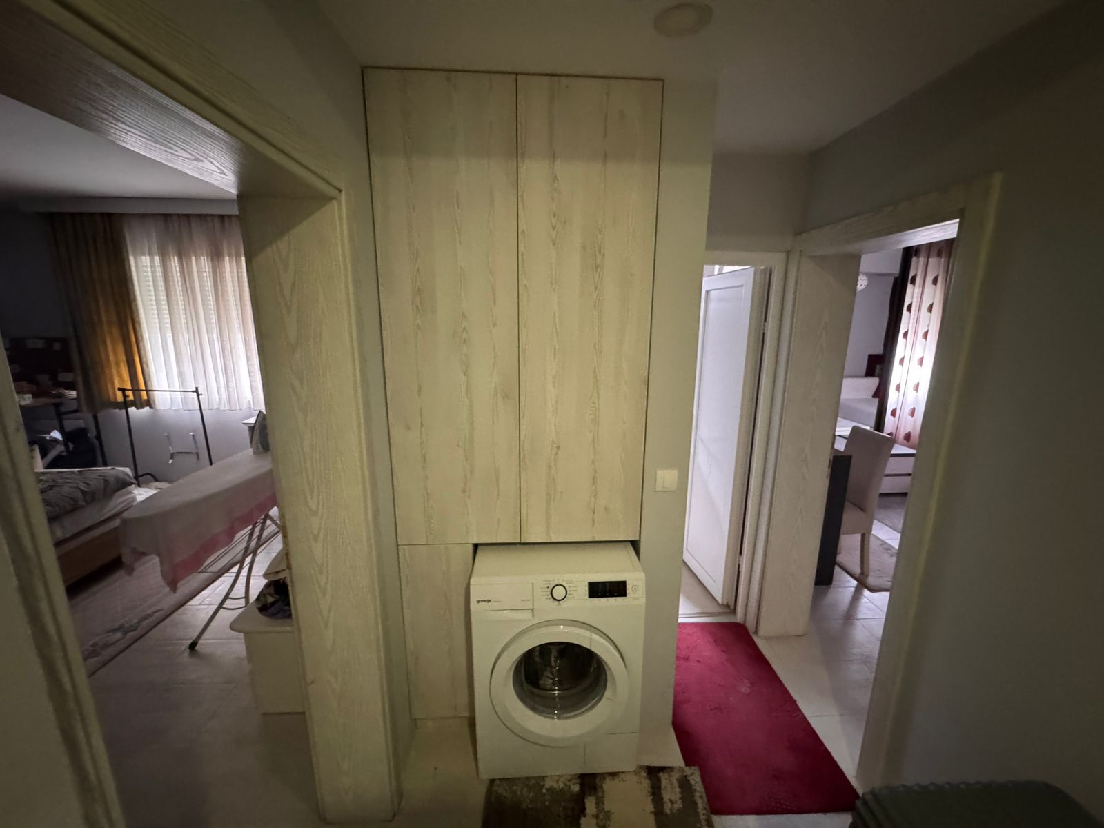 Well-maintained tiled hallway with built-in storage and laundry area, leading to bedrooms&mdash;ideal Ulcinj investment via immobilien.ekosphere.me.