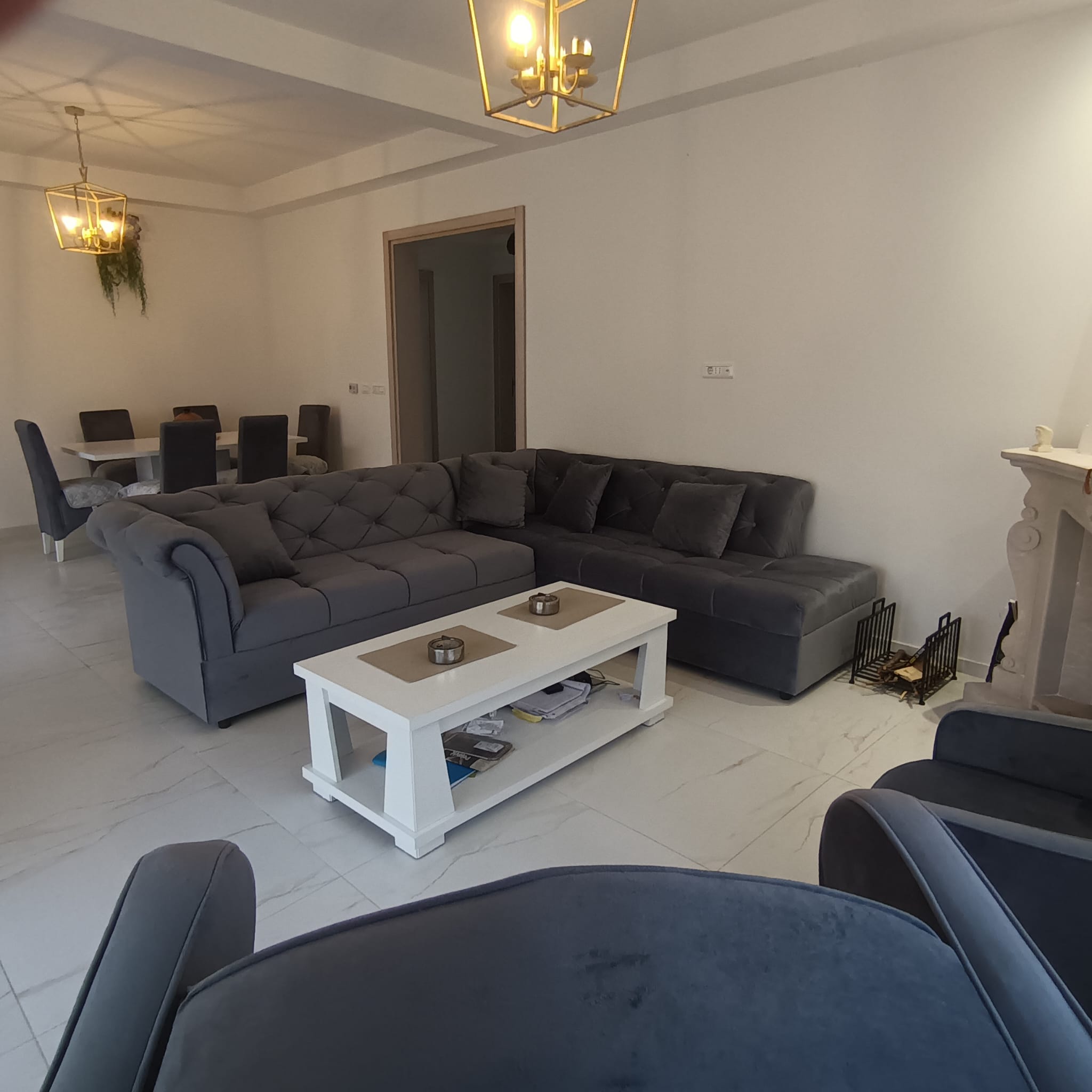 Luxurious Ulcinj apartment: spacious living room with gray sofas, marble floors, dining area. Exclusive at immobilien.ekosphere.me by ekosphere doo.
