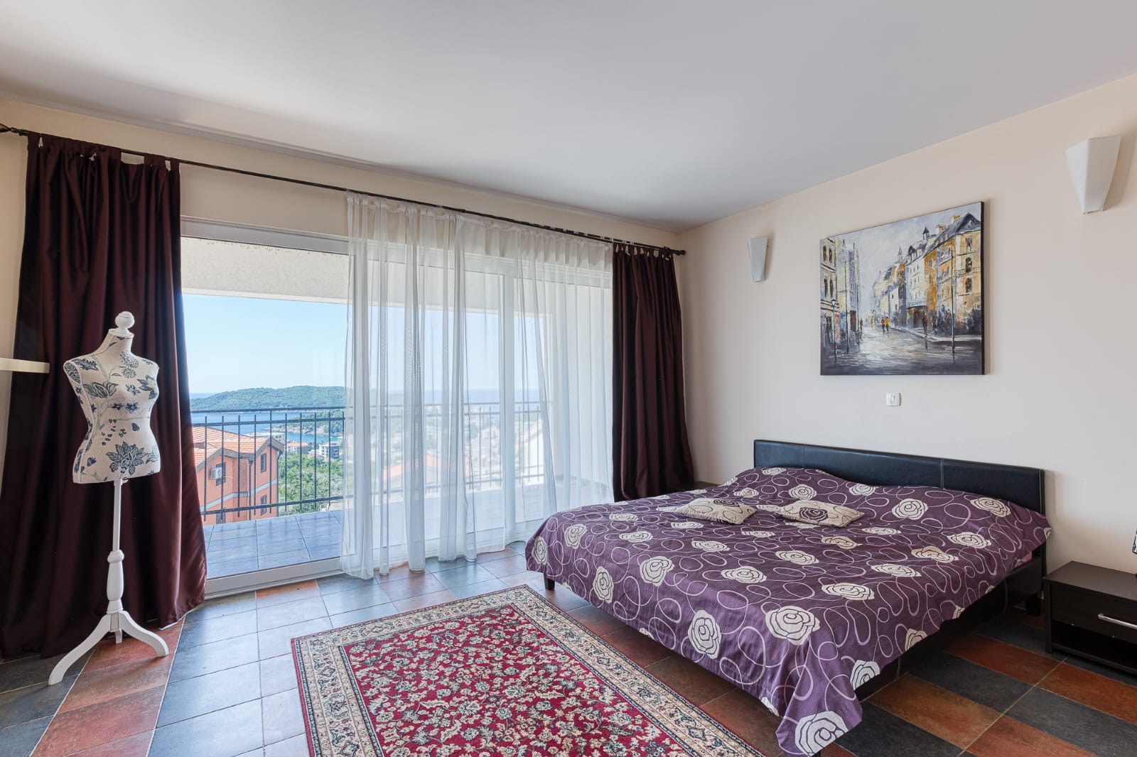 Elegant Ulcinj bedroom with double bed, modern decor, full-length windows, private balcony&mdash;prime real estate via immobilien.ekosphere.me.