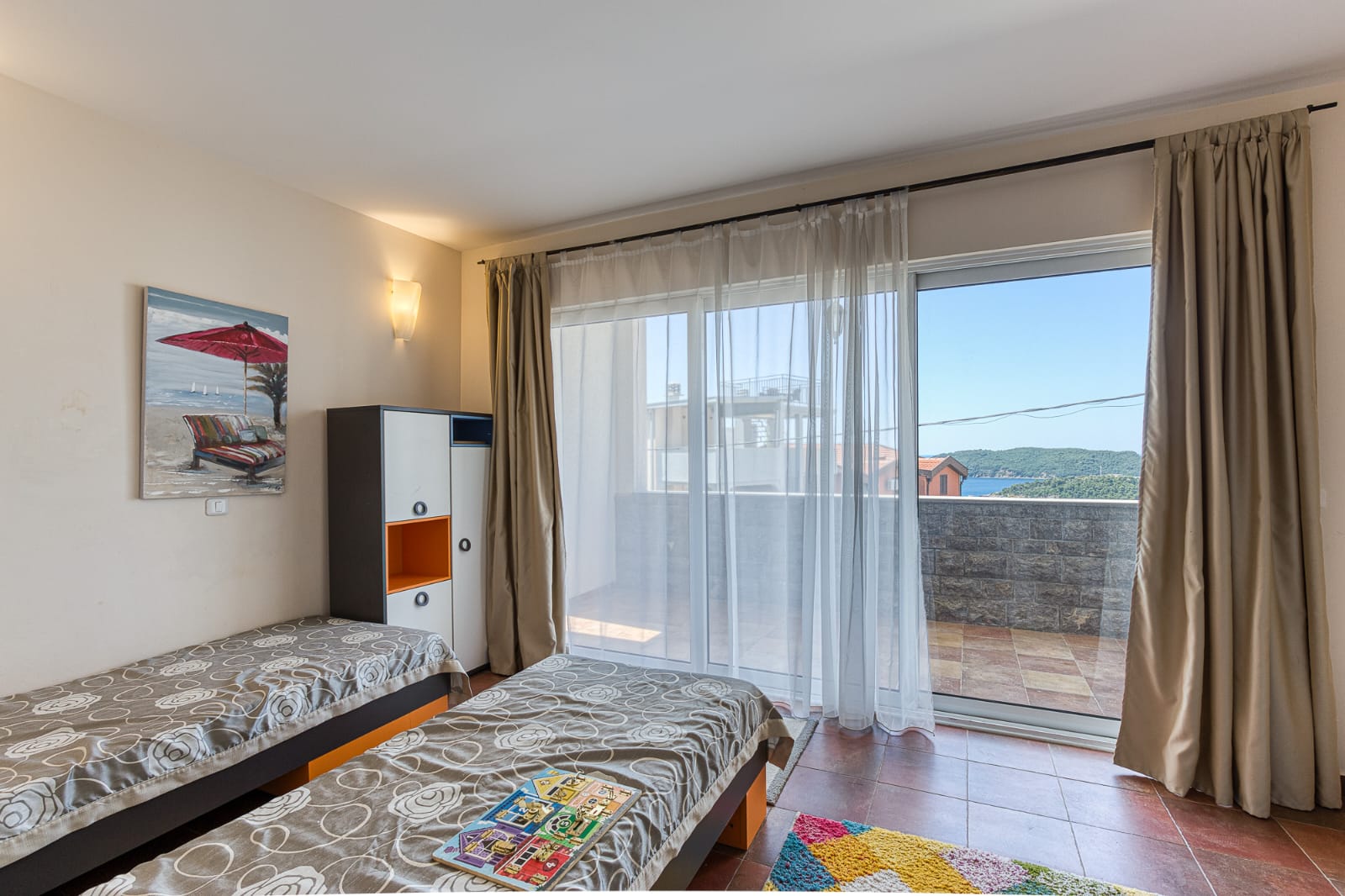 Bright Ulcinj bedroom with twin beds, balcony access, stylish decor&mdash;ideal Montenegro real estate from immobilien.ekosphere.me by ekosphere doo.
