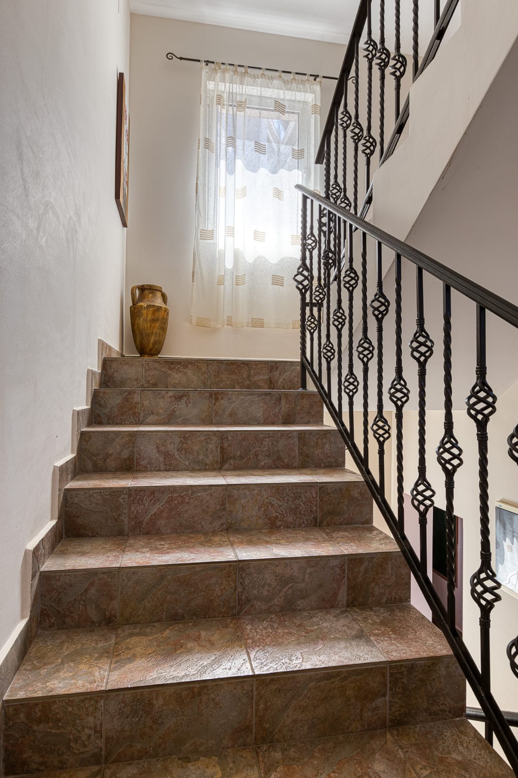 Elegant tiled staircase with modern railings, natural light, and upscale d&eacute;cor&mdash;prime Ulcinj real estate by immobilien.ekosphere.me.