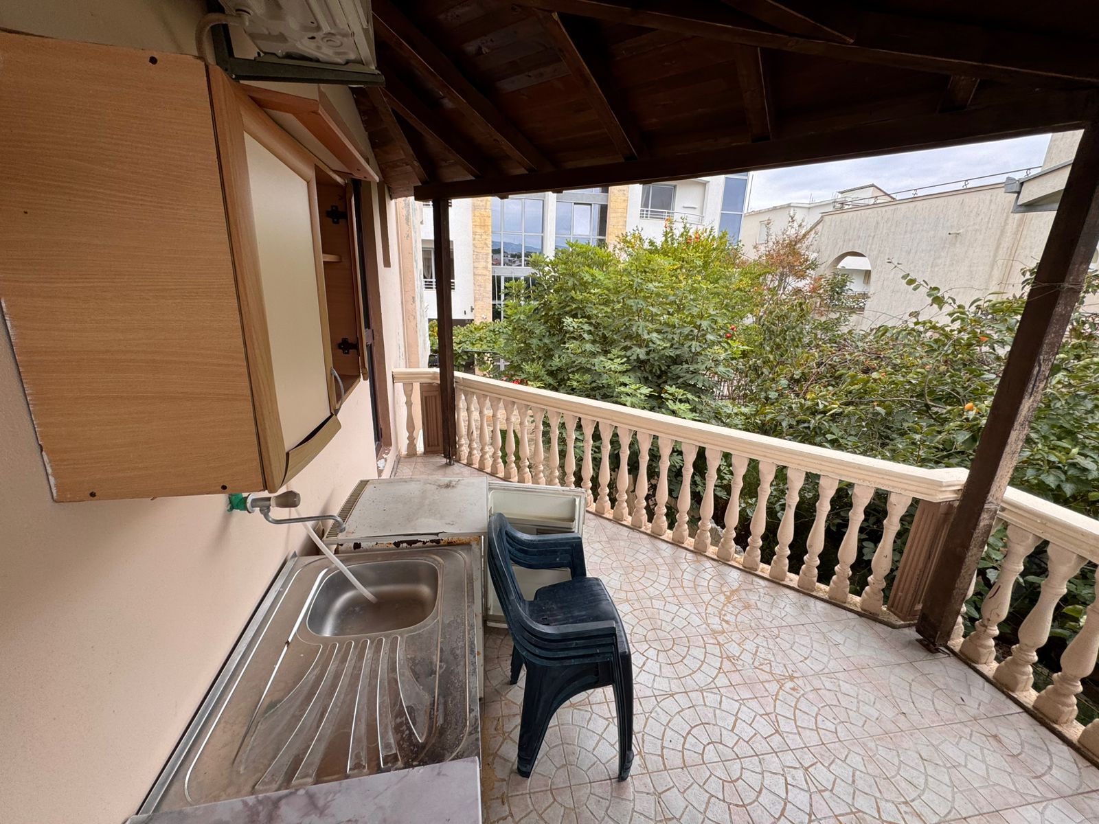 Charming tiled balcony in Ulcinj with outdoor kitchen, storage, and scenic views&mdash;ideal Montenegro investment by ekosphere doo.