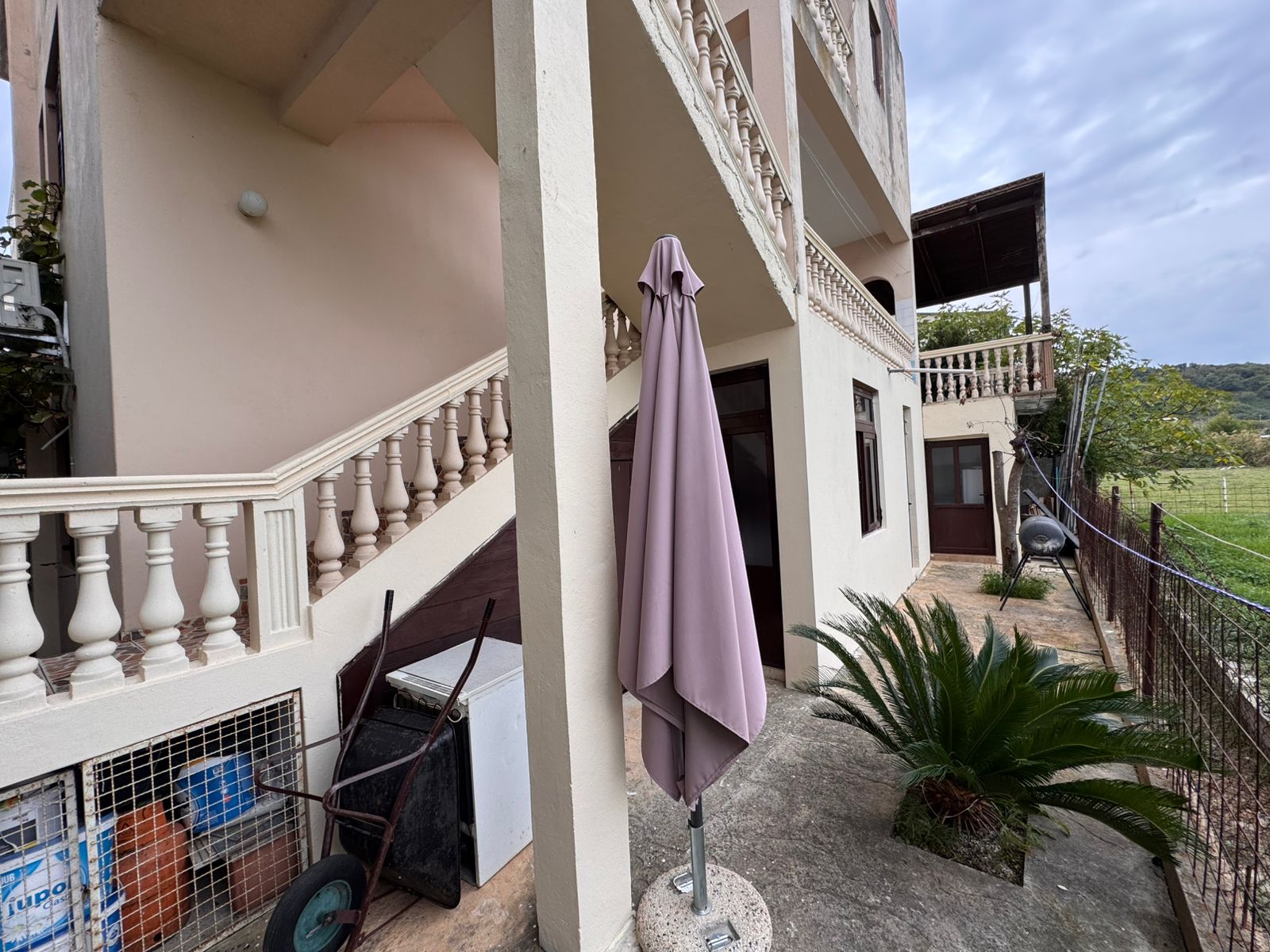 Modern beige two-story home in Ulcinj, Montenegro with private patio and garden, ideal for investment; listed on immobilien.ekosphere.me.