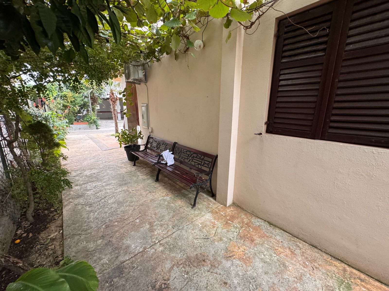 Charming Ulcinj property: Enjoy peaceful outdoor seating by lush greenery and classic shutters. Exclusive on immobilien.ekosphere.me, a project of ekosphere doo.