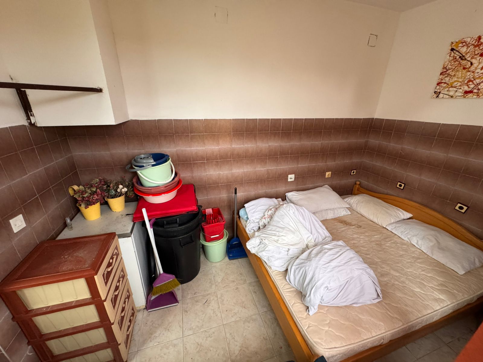 Charming Ulcinj investment: cozy tiled room with double bed, storage, and potential. Listed by immobilien.ekosphere.me, ekosphere doo.