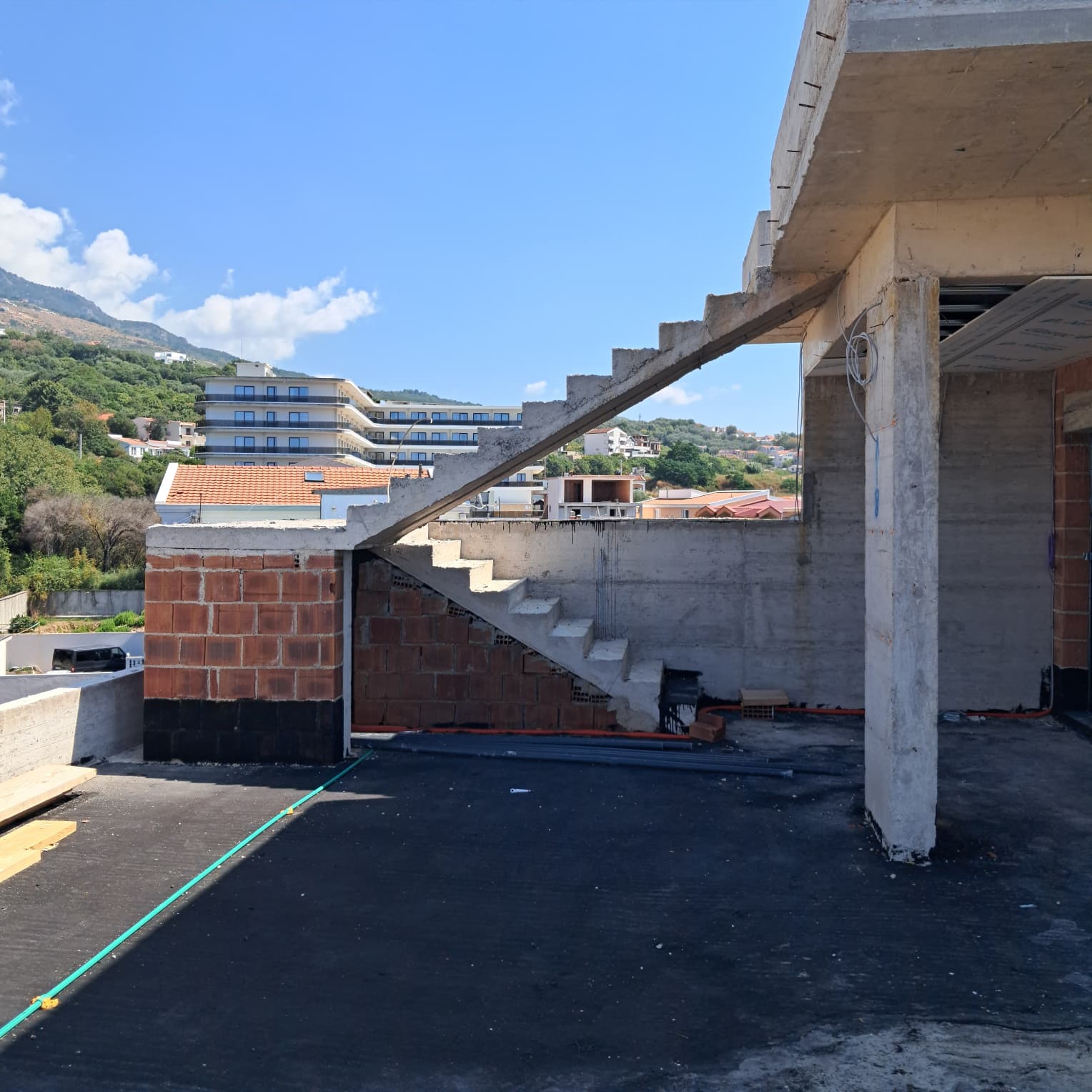 Prime Ulcinj investment: unfinished property with concrete stairs, exposed brick, scenic views. Listed by immobilien.ekosphere.me/Ekosphere DOO.