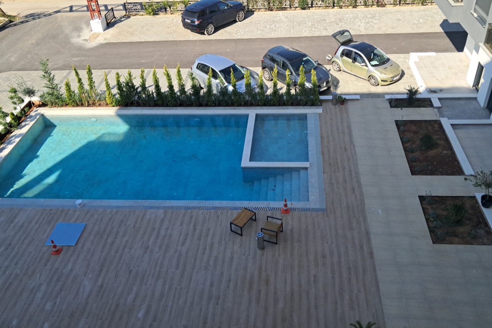 Luxury Ulcinj real estate: tiled patio, twin pools, stylish seating. Secure parking & privacy. immobilien.ekosphere.me by ekosphere doo.